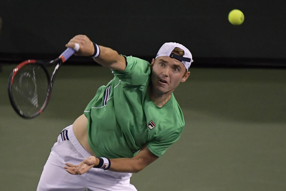 Bjorn Fratangelo serves to Novak Djokovic, of Serbia, at the BNP Paribas Open tennis tournament Saturday, March 9, 2019, in Indian Wells, Calif. (AP Photo/Mark J. Terrill)