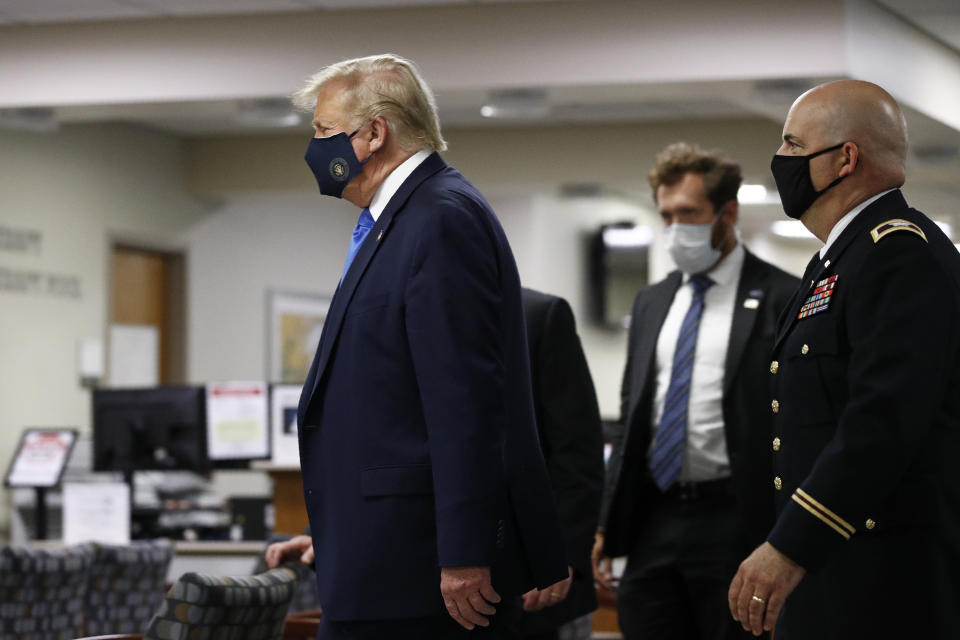 President Donald Trump wears a face mask as he walks down a hallway during a visit to Walter Reed National Military Medical Center in Bethesda, Md., Saturday, July 11, 2020. (AP Photo/Patrick Semansky)