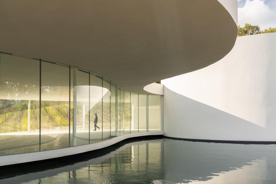 Oscar Niemeyer&#x002019;s pavilion at Ch&#xe2;teau La Coste consists of an exhibition space and auditorium. The modern building is a classic Niemeyer design with curved architecture and an abundance of glass.