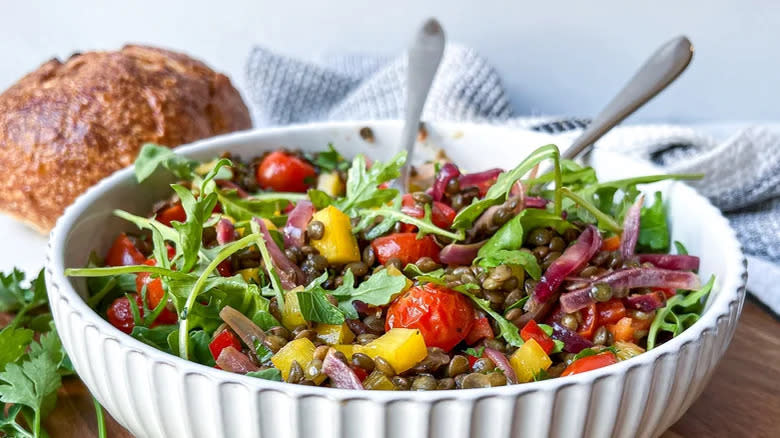 Arugula, lentils, and vegetables in serving bowl