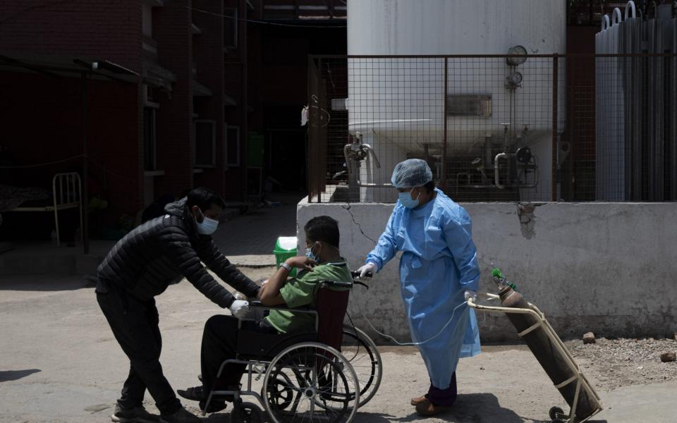 Covid-19 patients are being treated outside a hospital as wards are fully occupied at hospitals in Kathmandu. Nepal is struggling with record numbers of Covid-19 infections - NARENDRA SHRESTHA/EPA-EFE/Shutterstock 