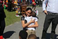<p>The Duchess of Sussex, Megan Markle, gets a warm embrace from one of the youngsters during her visit to Cape Town, Africa on September 30, 2019. She was attending an event for The Justice Desk, an initiative that teaches children about their rights and provides self-defense classes and female empowerment for young girls in the community. </p>