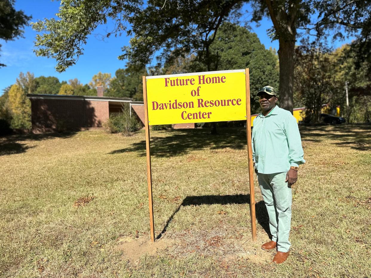 Randy Miller, president of the Davidson Alumni Resource Center, stands in front of the sign at Davidson Elementary School in Kings Mountain.