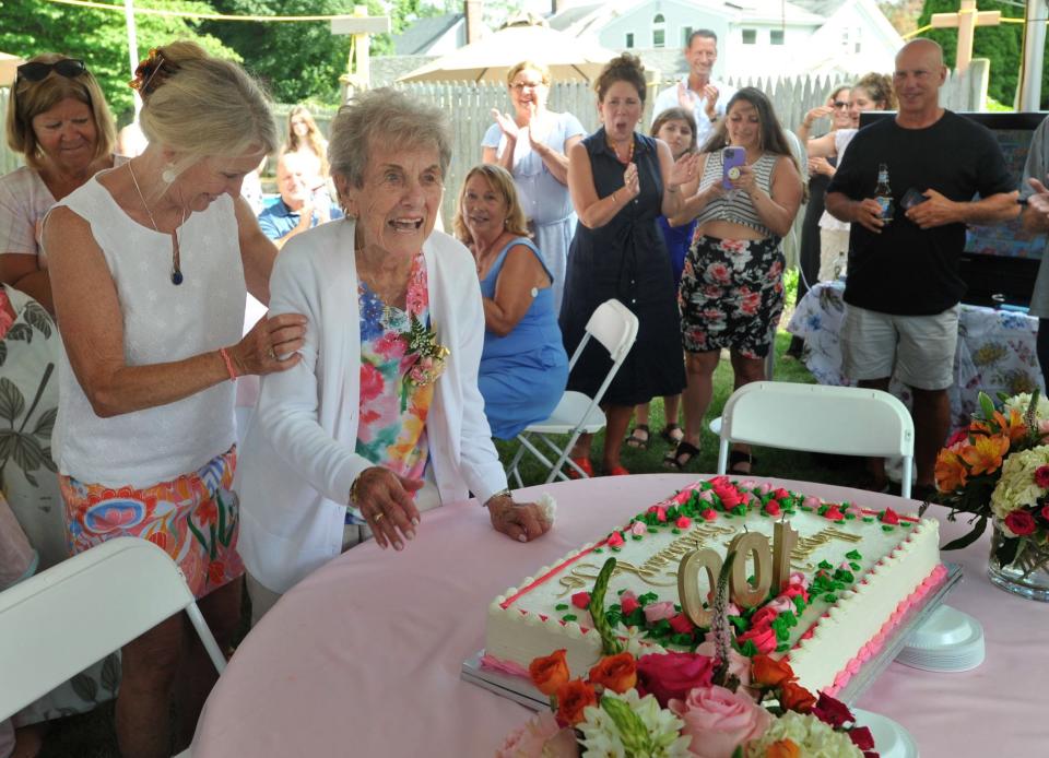 Family and friends applaud Jo Sharp, second from left, as she celebrates her 100th birthday at her Braintree home with her daughter, Nancy McGrory, left, Saturday, July 22.