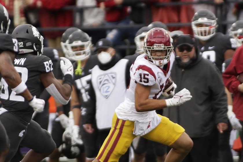 Southern California wide receiver Drake London (15) carries the ball while pursued by Washington State linebacker.