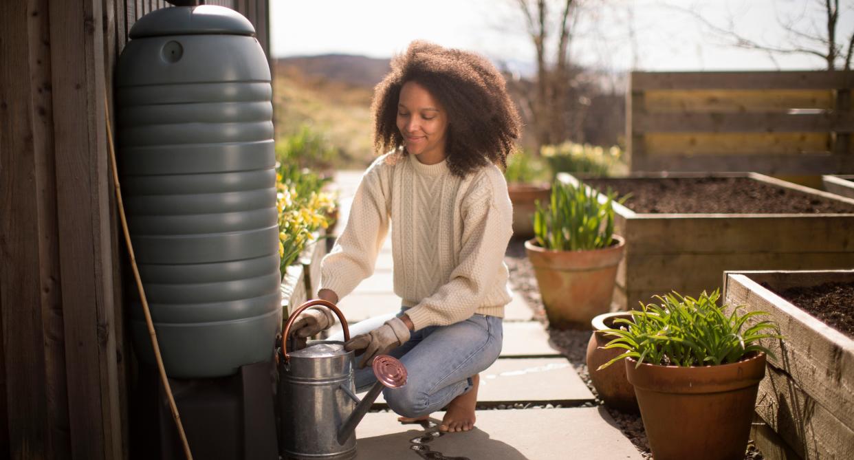 Woman using a free water butt