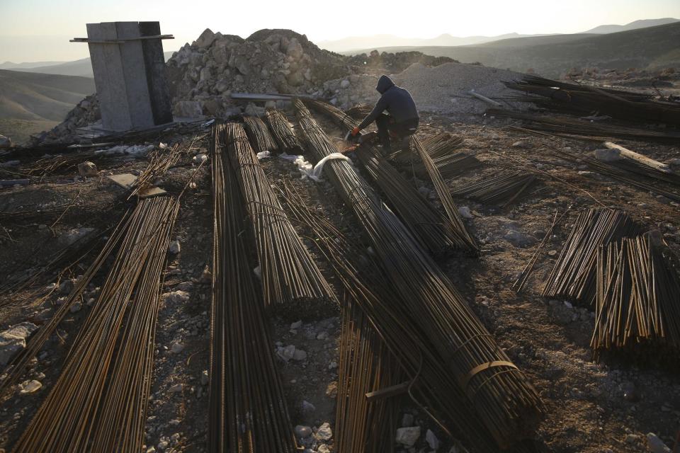 FILE -- In this Feb. 7, 2017 file photo, a Palestinian laborer works at a construction site in a new housing project in the Israeli settlement of Maale Adumim, near Jerusalem. The Trump administration appears to be easing away from longstanding U.S. support for Palestinian statehood as the preferred outcome of Middle East peace efforts, which may please some allies of Prime Minister Benjamin Netanyahu in Israel. But the alternatives are few, and each comes with daunting and combustible complications, including for Israel itself. (AP Photo/Oded Balilty, File)