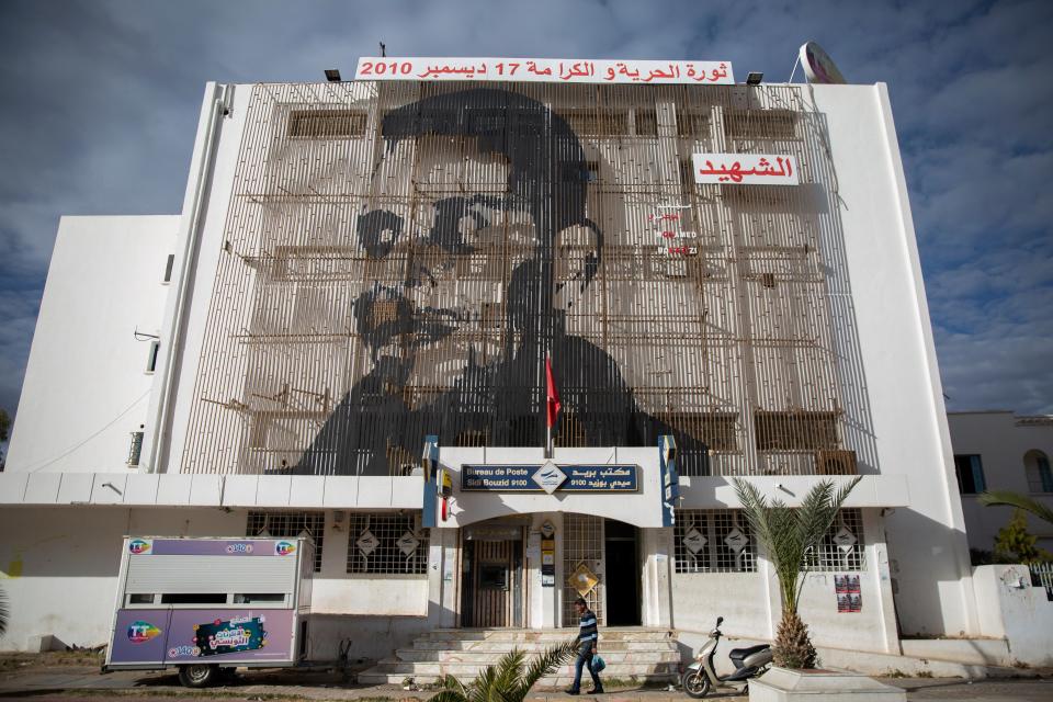 <p>Mohammed Bouazizi depicted on the facade of post office in Sidi Bouzid</p>AP