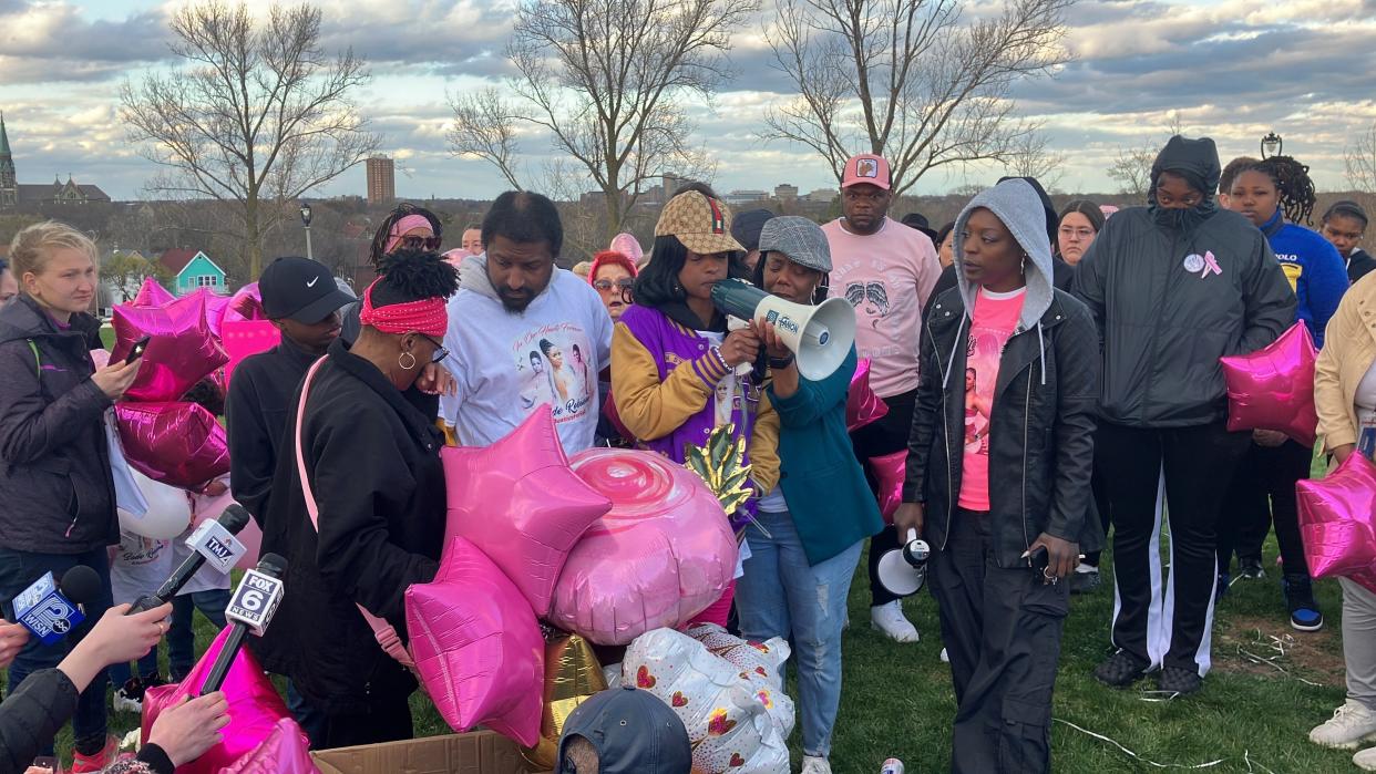 Sheena Scarbrough, mother of Sade Robinson, stands with family and friends as she addresses the crowd at her daughter's vigil on Friday in Milwaukee.