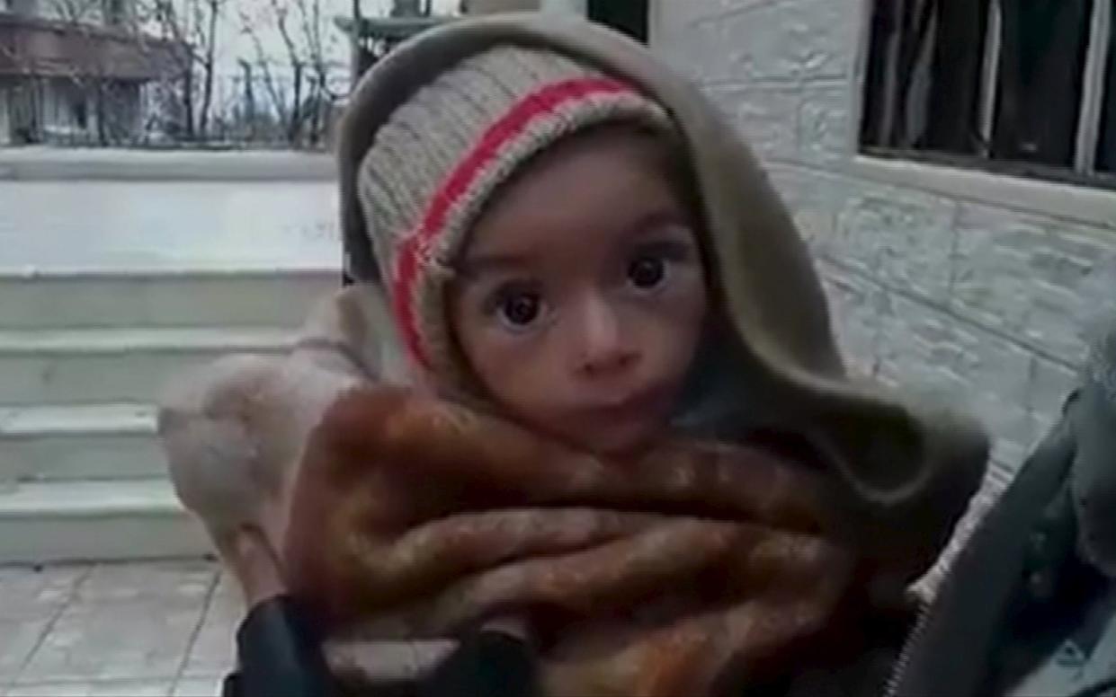 A toddler is held up to the camera in this still image taken from video said to be shot in Madaya on January 5, 2016 - Handout