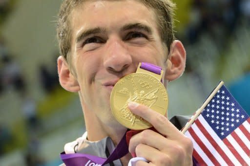 Gold medalist USA's Michael Phelps kisses his gold medal after the podium ceremony of the men's 4x200m freestyle relay final during the swimming event at the London 2012 Olympic Games on July 31, 2012 in London