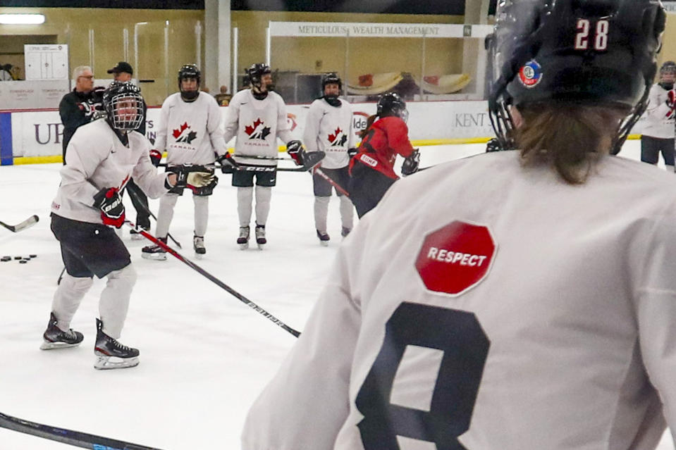 In this photo taken Monday, Nov. 4, 2019, Micah Hart, right, of the Canada Women's National hockey team, wears a "respect" patch on the back of a practice sweater as they go through drills during a practice in Cranberry Township, Butler County, Pa. Many of the top women’s hockey players on the planet say they’re resolute in their decision to not play professionally in North America until a new league that provides better pay and better benefits materializes. (AP Photo/Keith Srakocic)