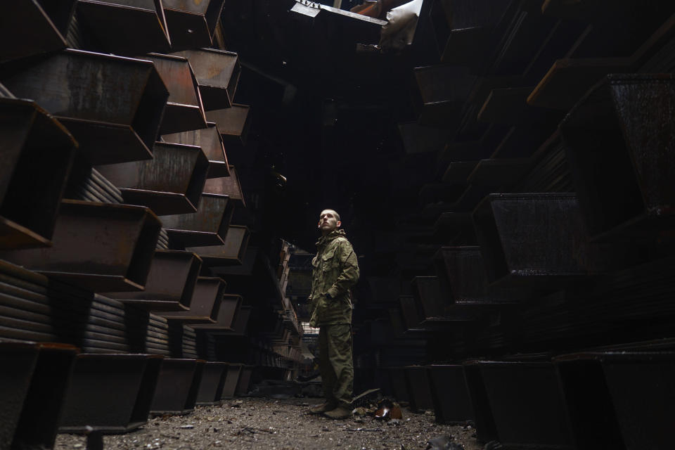 In this photo provided by Azov Special Forces Regiment of the Ukrainian National Guard Press Office, a Ukrainian soldier stands inside the ruined Azovstal steel plant prior to surrender to the Russian forces in Mariupol, Ukraine, May 19, 2022. For nearly three months, Azovstal’s garrison clung on, refusing to be winkled out from the tunnels and bunkers under the ruins of the labyrinthine mill. A Ukrainian soldier-photographer documented the events and sent them to the world. Now he is a prisoner of the Russians. His photos are his legacy.(Dmytro Kozatski/Azov Special Forces Regiment of the Ukrainian National Guard Press Office via AP)