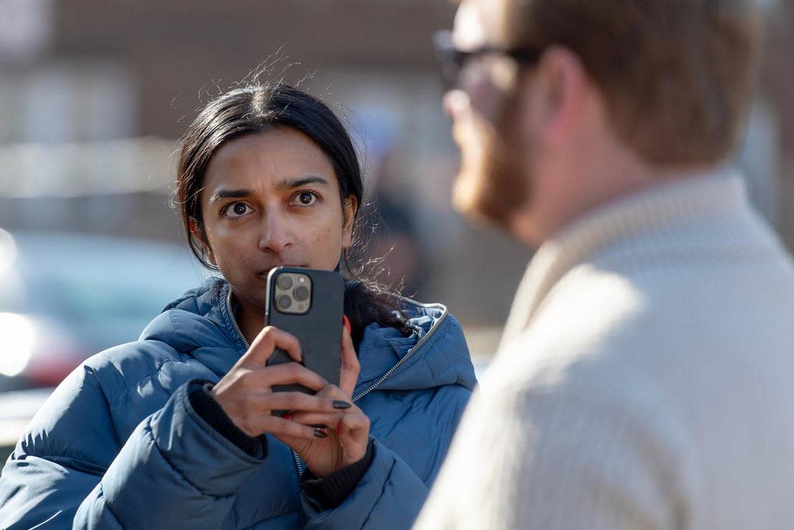 Tara Raghuveer, director of KC Tenants, records comments made by Mike Hardin, a public relations consultant for FTW Investments, outside of a northeast apartment complex on Monday, Jan. 23, 2023, in Kansas City.