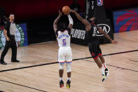 Oklahoma City Thunder's Luguentz Dort (5) has his 3-point attempt blocked by Houston Rockets' James Harden (13) as referee Pat Fraher, left rear, looks on during the second half of an NBA first-round playoff basketball game in Lake Buena Vista, Fla., Wednesday, Sept. 2, 2020. (AP Photo/Mark J. Terrill)