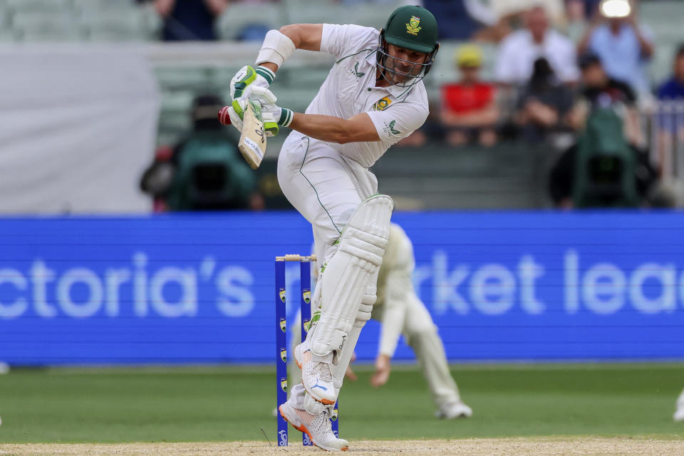 South Africa's Dean Elgar hits the ball and is caught of the bowling of Australia's Pat Cummins during the second cricket test between South Africa and Australia at the Melbourne Cricket Ground, Australia, Wednesday, Dec. 28, 2022. (AP Photo/Asanka Brendon Ratnayake)