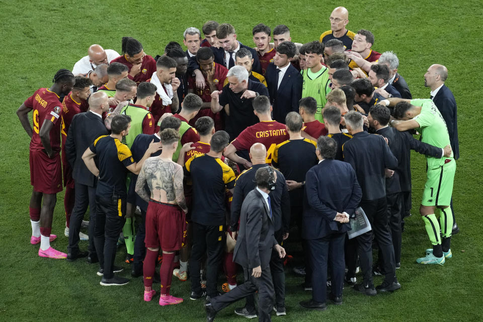 Roma's head coach Jose Mourinho talks to his players after the Europa League final soccer match between Sevilla and Roma, at the Puskas Arena in Budapest, Hungary, Wednesday, May 31, 2023. Sevilla won 5-2 following a penalty shootout. (AP Photo/Darko Vojinovic)