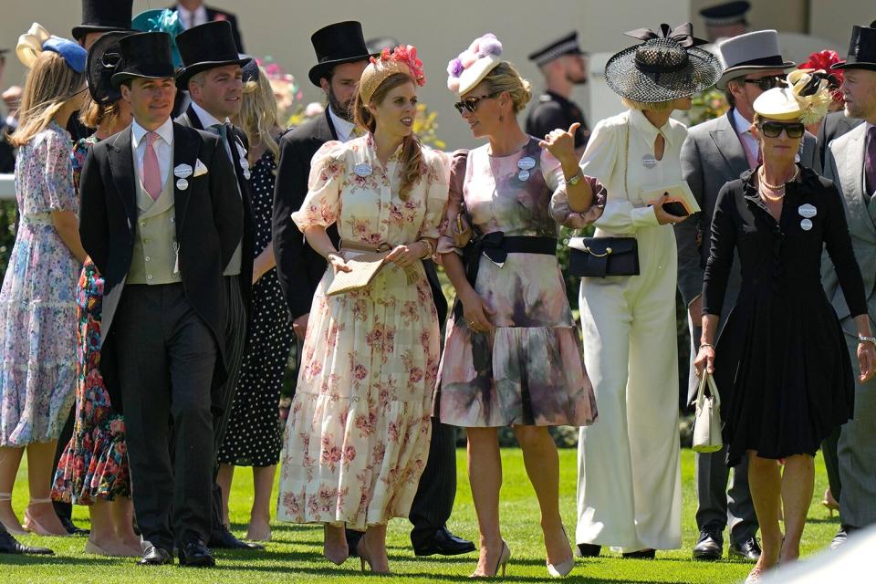 Princess Beatrice, center left, and Zara Tindall, center right, chat as they stand in the paddock on day one of the Royal Ascot horse racing meeting