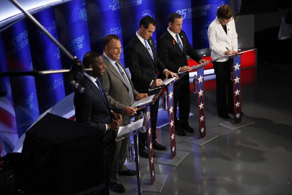 Democratic gubernatorial candidates, from right, Gwen Graham, Philip Levine, Chris King, Jeff Greene and Andrew Gillum await the start of a debate ahead of the Democratic primary for governor, Thursday, Aug. 2, 2018, in Palm Beach Gardens, Fla. (AP Photo/Brynn Anderson)
