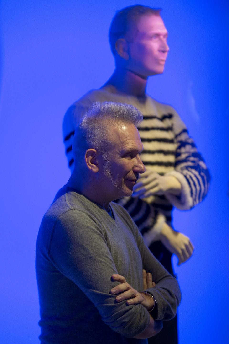 French fashion designer Jean Paul Gaultier poses next to his effigy during the opening of the exhibit "The Fashion World of Jean Paul Gaultier, from the sidewalk to the catwalk", at Kunsthal museum in Rotterdam, Netherlands, Friday Feb. 8, 2013. The exhibit open Feb. 10, 2013. (AP Photo/Peter Dejong)