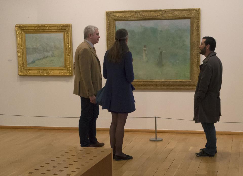 People look at a painting by American painter Thomas Wilmer Dewing, 1851-1938, "Summer", 1890, during the exhibition "American Impressionism: A New Vision", at the Impressionist museum in Giverny, 70 kms (45 mls)north west of Paris, during the Friday, March 28, 2014. A new exhibit at Normandy’s Impressionism Museum tells for the first time the little-known story of American Impressionism from where it all began _ at the picturesque water lily-filled Giverny gardens of Claude Monet that Americans colonized for three decades. (AP Photo/Michel Euler)