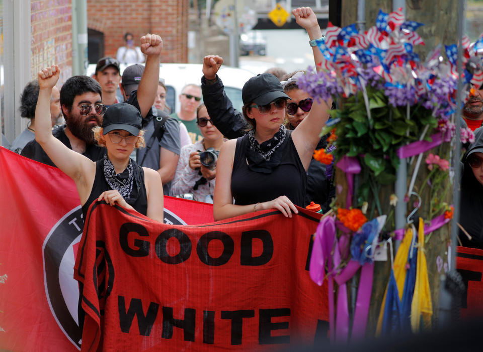 <p>A group wearing anti-fascist labels visits the site where Heather Heyer was killed during the 2017 Charlottesville “Unite the Right” protests in Charlottesville, Va., Aug. 11, 2018. (Photo: Brian Snyder/Reuters) </p>