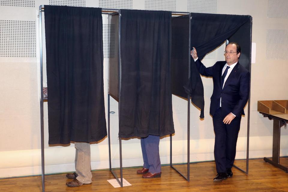 French president Francois Hollande prepares to vote in the municipal elections at a polling station in Tulle, center of France, Sunday, March 23, 2014. The first round of municipal elections in France has far right candidates hoping for a strong showing, which could give them a grass roots base upon which to grow nationally. It's also seen as a test of the resiliency of France's governing Socialists, who swept to victory six years ago. (AP Photo/Nicolas Tucat, Pool)