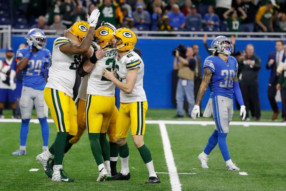 Green Bay Packers surround kicker Mason Crosby after his winning field goal against Detroit.