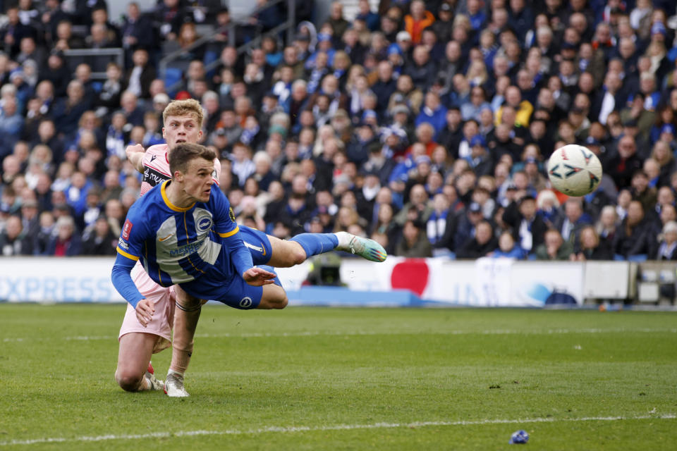 Brighton's Solly March, foreground, scores his side's fourth goal with a header during the English FA Cup quarterfinals soccer match between Brighton & Hove Albion and Grimsby Town at the AMEX Stadium in Brighton, England, Sunday, March 19, 2023. (AP Photo/David Cliff)