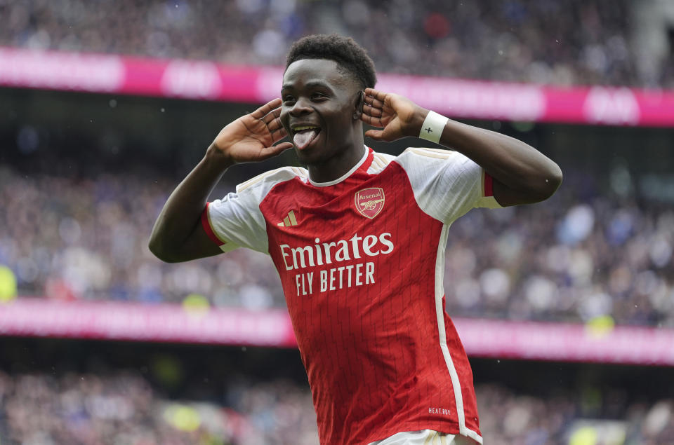 Arsenal's Bukayo Saka celebrates after scoring his side's second goal during the English Premier League soccer match between Tottenham Hotspur and Arsenal at the Tottenham Hotspur Stadium in London, England, Sunday, April 28, 2024. (Zac Goodwin/PA via AP)