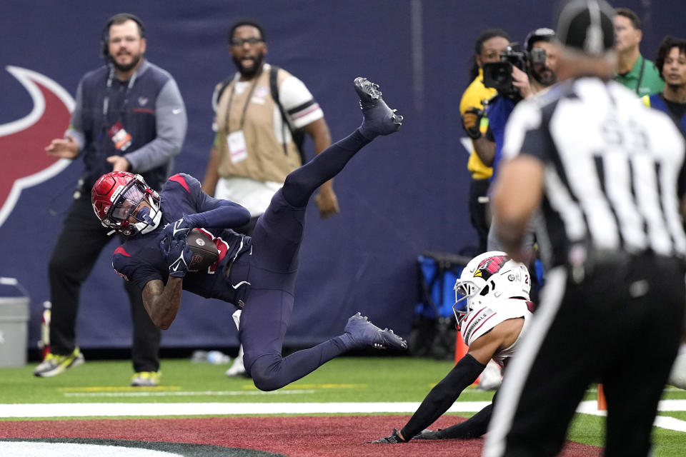 Houston Texans wide receiver Tank Dell catches a touchdown pass in the first half of an NFL football game against the Arizona Cardinals in Houston, Sunday, Nov. 19, 2023. (AP Photo/David J. Phillip)