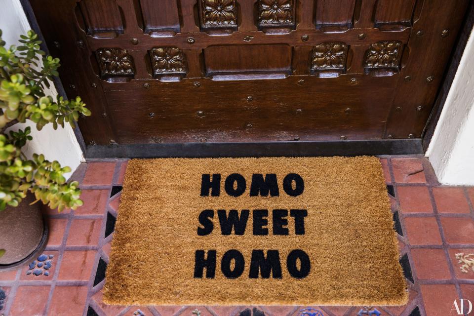 A “Homo Sweet Homo” doormat the couple picked up is the first sign of the sense of humor they bring to their interior design.