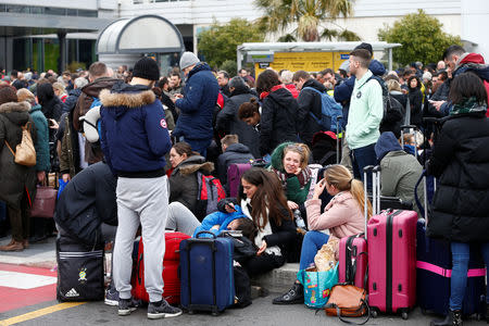 Passengers who were evacuated due to a fire at Ciampino Airport in Rome, Italy, February 19, 2019 gather outside the teminal building. REUTERS/Yara Nardi