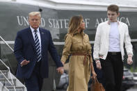 FILE - In this Aug. 16, 2020 file photo, President Donald Trump, first lady Melania Trump and their son, Barron Trump, walk off of Marine One and head toward Air Force One at Morristown Municipal Airport in Morristown, N.J. (AP Photo/Susan Walsh)