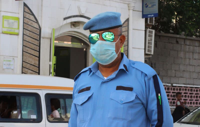 A police officer wearing a protective face mask is pictured on a street during a curfew amid concerns about the spread of the coronavirus disease (COVID-19) in Aden