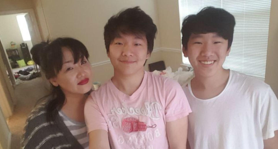 Brothers Eric and Randy with their mum, Hyun Jung Grant.