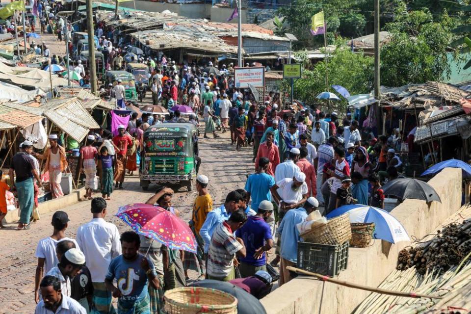 Rohingya refugees gather at a market