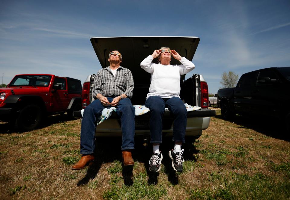 Gary and Marsha Smith from Nixa, Mo. view the solar eclipse from the back of their truck in West Plains, Mo. on Monday, April 8, 2024.
