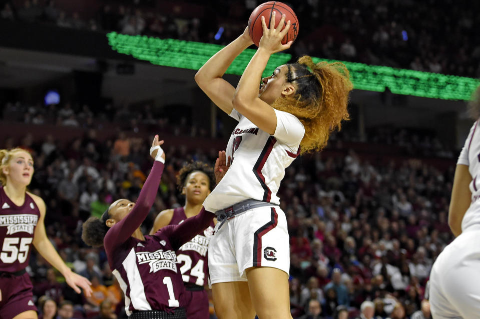 South Carolina's Brea Beal (12) shoots while defended by Mississippi State's Myah Taylor (1) during a championship match at the Southeastern Conference women's NCAA college basketball tournament in Greenville, S.C., Sunday, March 8, 2020. (AP Photo/Richard Shiro)