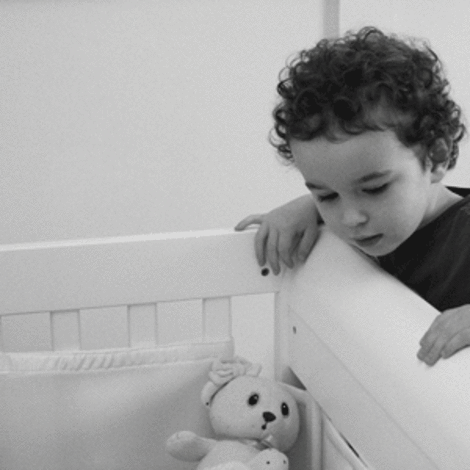 Boy Looking In Crib