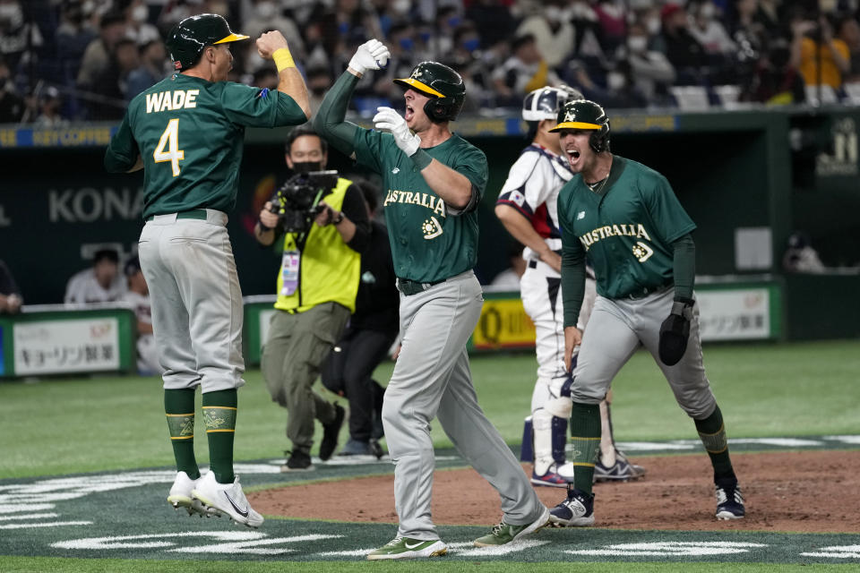 Robert Perkins of Australia, center, celebrates with teammates Jarryd Dale, right, and Logan Wade after Perkins hit a 3-run home rung off South Korea's pitcher Yang Hyeon-jong during their Pool B game at the World Baseball Classic in Tokyo, Japan, Thursday, March 9, 2023. (AP Photo/Shuji Kajiyama)