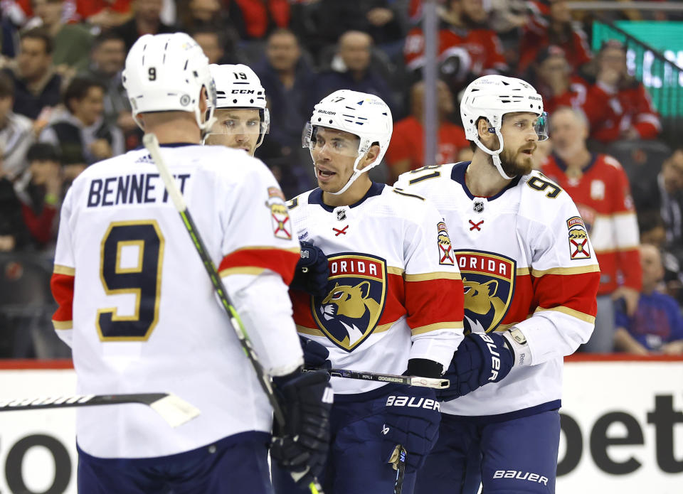 Florida Panthers center Evan Rodrigues (17) celebrates with teammates Sam Bennett (9), Matthew Tkachuk (19) and Oliver Ekman-Larsson (91), after scoring a goal against the New Jersey Devils during the first period of an NHL hockey game, Tuesday, March 5, 2024, in Newark, N.J. (AP Photo/Noah K. Murray)