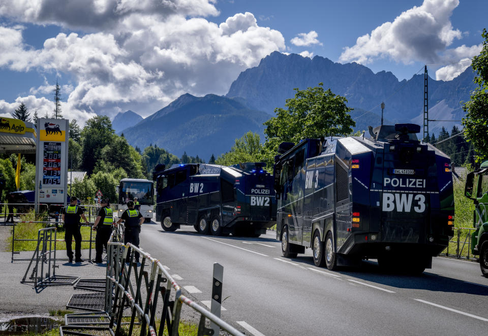 German police water canons approach a gas station to pick up gas in Klais near Elmau, Germany, Saturday, June 25, 2022. The G7 summit will start on Sunday. (AP Photo/Michael Probst)