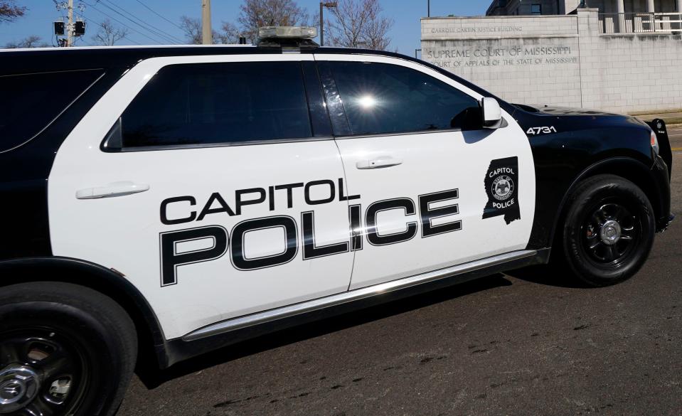 Capitol Police respond to a bomb threat at the Mississippi State Capitol and the Mississippi Supreme Court building, background,, Thursday morning, Jan. 4, 2024, in Jackson, Miss.