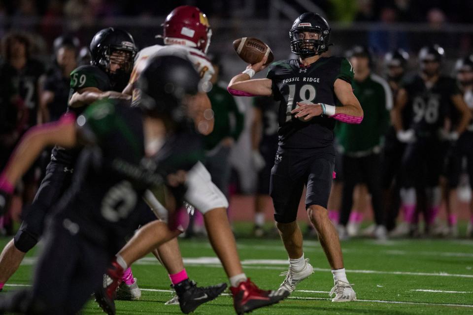 Fossil Ridge High School quarterback Tyler Kubat throws the football to a receiver during the SaberCats' game against Rocky Mountain at PSD Stadium in Timnath on Friday, Oct. 14, 2022.