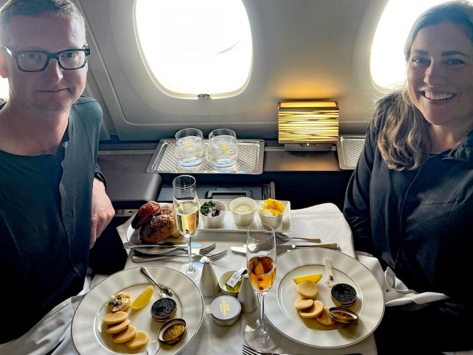 couple eating a meal together on a first-class flight