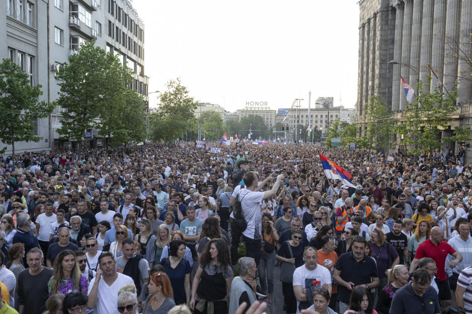 People walk down a street during a protest in Belgrade, Serbia, Saturday, June 3, 2023. Tens of thousands of people rallied in Serbia's capital on Saturday in protest of the government's handling of a crisis after two mass shootings in the Balkan country. (AP Photo/Marko Drobnjakovic)