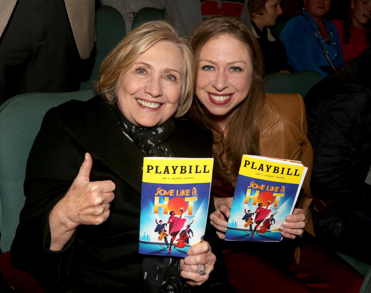 Hillary and Chelsea Clinton hold up their programs while attending "Some Like It Hot" The Shubert Theater on March 14, 2023 in New York City.