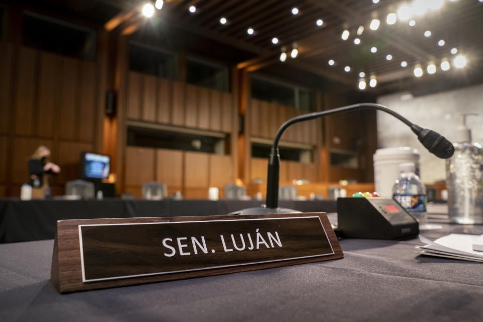 The placard for Sen. Ben Ray Luján, D-N.M., is set out in his absence at a hearing by the Senate Health, Education, Labor, and Pensions Committee, on Capitol Hill in Washington, Tuesday, Feb. 15, 2022. Luján, who's recovering from a stroke, says he plans to be back at work in the Senate in "just a few short weeks" so he can vote on President Joe Biden's forthcoming nominee for the Supreme Court. His vote in the 50-50 Senate would be critical to the Democrats. (AP Photo/J. Scott Applewhite)