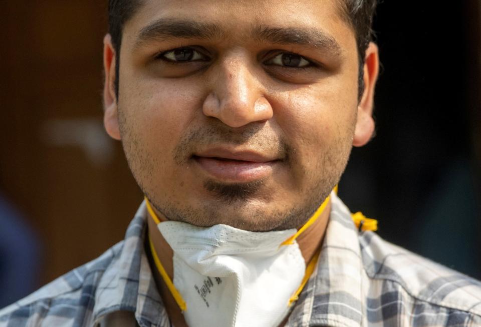 Rohan Aggarwal, 26, a resident doctor who treats patients suffering from coronavirus disease (COVID-19), poses for a photograph as he arrives for a 27-hour shift at Holy Family Hospital in New Delhi, India, May 1, 2021. Aggarwal says he fears what will happen if he gets infected, too, knowing that his own hospital will be unlikely to find him a bed. He is unvaccinated: He was sick in January when shots for medical professionals were being rolled out, and then by February, he began to relax. “We were all under the misconception the virus had gone,” he said. REUTERS/Danish SiddiquiREUTERS